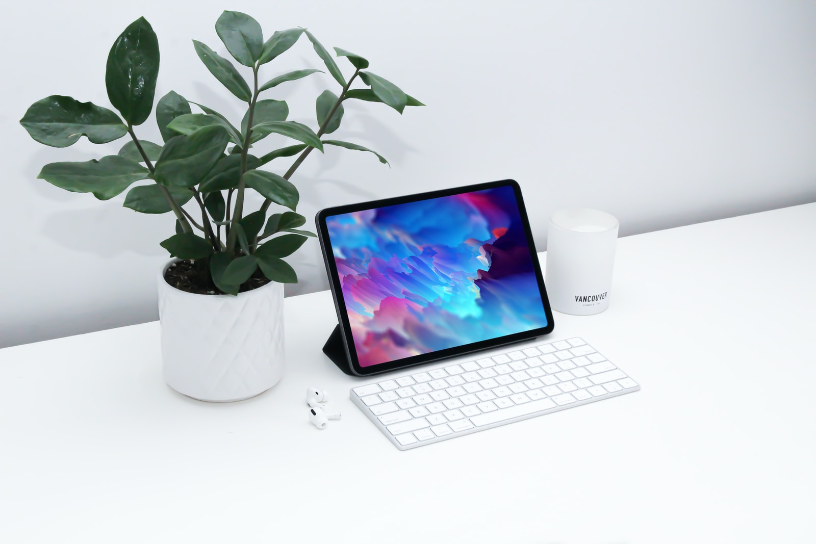 white ipad on white wooden table