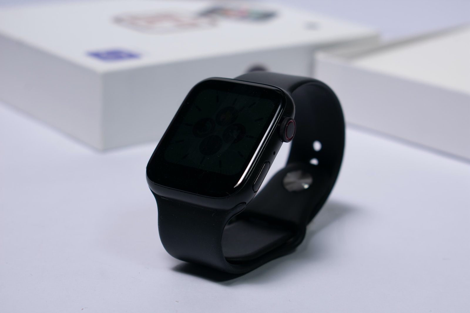 black aluminum case Apple Watch and black Fitbit charge 2